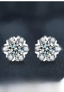 Macro detail of S925 sterling silver snowflake stud earrings featuring moissanite stones