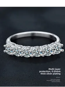 Detail of 925 sterling silver ring featuring five round stones with polished finish