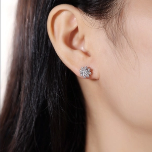 Elegant S925 sterling silver snowflake stud earrings with sparkling moissanite on ear