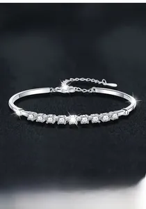 Close-up of S925 sterling silver moissanite bracelet with adjustable chain on black texture