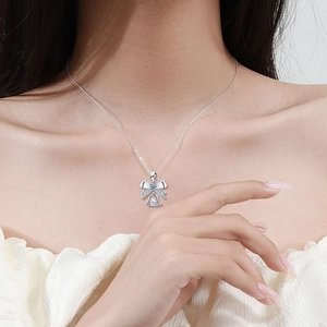 S925 silver bow bell necklace with teardrop moissanite pendant worn by model