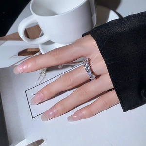 Elegant S925 sterling silver eternity ring with sparkling moissanite stones on a finger
