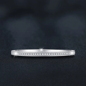 Minimalist S925 sterling silver band ring with sparkling moissanite stones on black background