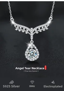 Macro shot of S925 sterling silver angel wing necklace with moissanite teardrop pendant