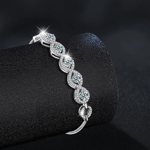 Luxury S925 sterling silver moissanite bracelet with intertwined wave design on display