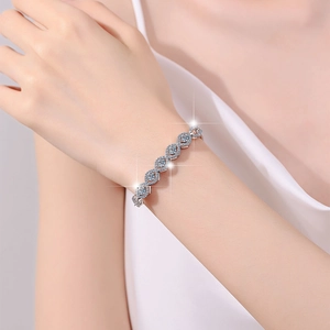 Elegant S925 sterling silver infinity bracelet with sparkling moissanite on model wrist