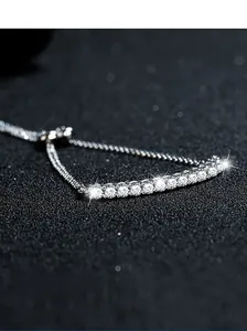 Macro detail of S925 sterling silver smile bracelet with pavé cubic zirconia diamonds