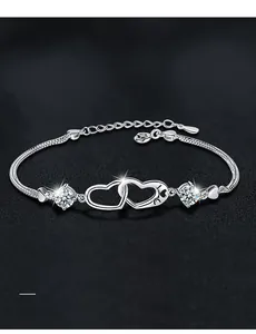 Macro shot of S925 silver double heart bracelet with radiant moissanite on black leather
