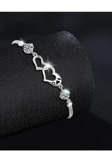 Detail of S925 silver interlocking hearts bracelet featuring sparkling round moissanite