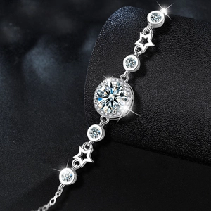 925 silver bracelet featuring moissanite center stone and hollow star charms on black background