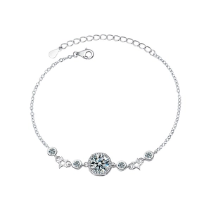 Sterling silver moissanite bracelet featuring a star charm and sparkling round pendant