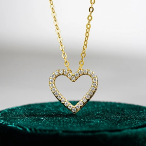 925 sterling silver heart necklace with moissanite in 14K gold finish on velvet