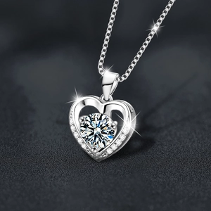 Elegant S925 silver heart necklace with sparkling moissanite pendant on black surface