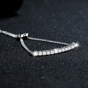 S925 silver moissanite smile bracelet featuring an adjustable chain on black background