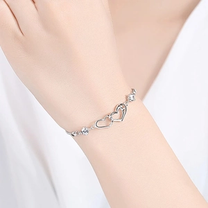 Elegant S925 silver double heart moissanite bracelet shown on woman's wrist