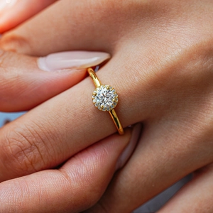 Luxurious 18K gold plated S925 silver round halo moissanite ring worn on finger