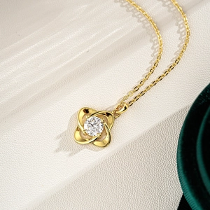 925 silver four-leaf clover moissanite necklace with 14K gold plating on stone surface