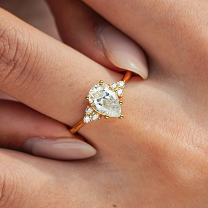 Pear-cut moissanite engagement ring in 18K gold-plated S925 silver on model hand