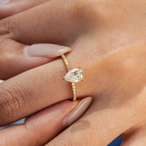 Pear cut moissanite ring in 18K gold plated S925 silver shown on a model hand