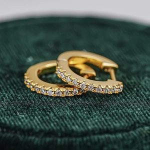 Macro shot of 18K gold plated S925 silver hoop earrings with round cut moissanite stones