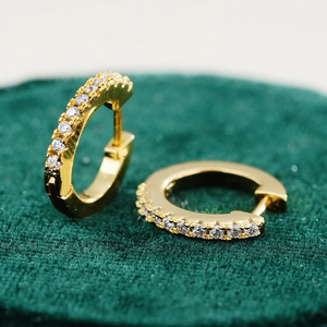 Macro shot of 18K gold plated S925 silver hoop earrings with white moissanite stones
