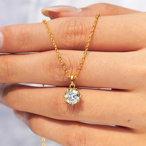 Classic 14K gold plated 925 silver snowflake necklace with moissanite pendant held by hand