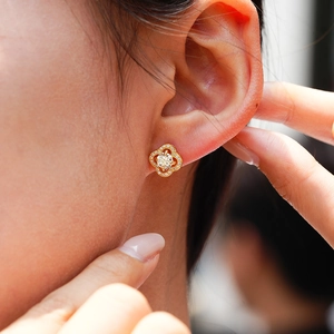 Elegant gold four-leaf clover stud earrings with brilliant moissanite stone setting