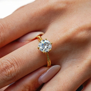 Classic six-prong 2ct moissanite ring with side accent stones on a gold-plated band