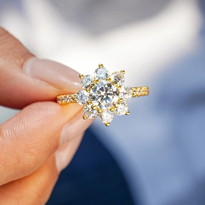 Sparkling sunflower 18K gold plated S925 silver ring with moissanite cluster held in hand