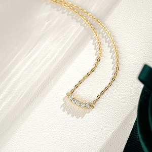 Elegant 14K gold plated 925 silver necklace with a curved five-stone moissanite smile pendant