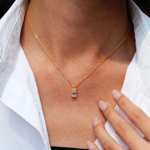 Rectangle emerald-cut moissanite necklace in 14K gold plated silver worn on a model