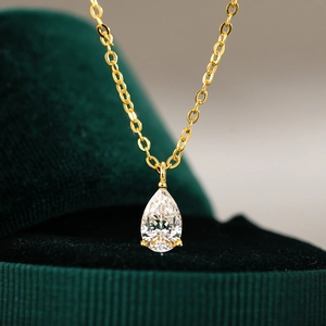 1 carat pear cut moissanite pendant necklace in 14K gold plated silver on velvet box