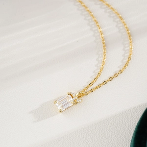 14K gold plated silver necklace featuring emerald cut pendant with moissanite accents