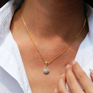 Teardrop pendant necklace in 14K gold plated silver with moissanite on a model