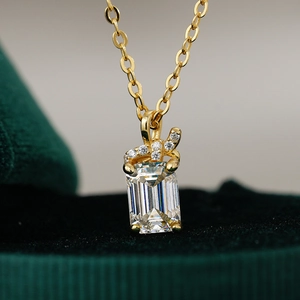 Close-up of rectangle emerald cut moissanite pendant on 14K gold plated O-chain