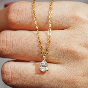 Pear-shaped moissanite necklace with 14K gold plated silver chain on female model skin