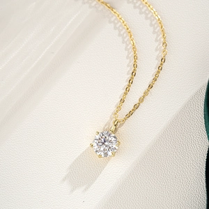 Macro view of 1ct moissanite pendant with 6-prong setting on 14K gold plated chain