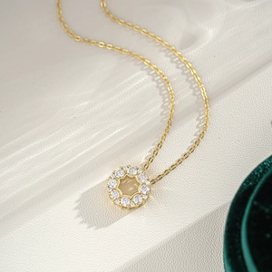 Gold 925 silver moissanite necklace with round pendant and starburst pattern