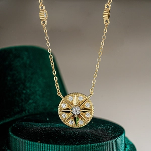 Macro shot of 14K gold plated 925 silver hexagram necklace on green velvet box