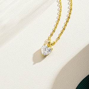 Detail of heart-cut moissanite pendant set in 14K gold-plated 925 silver with fine chain