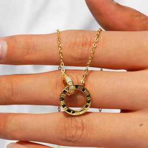 Gold-plated silver necklace featuring Roman numeral disc and white zircon pendant