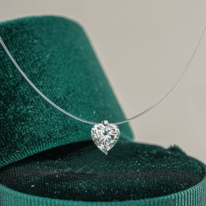 Elegant S925 silver heart moissanite pendant on invisible nylon string in a velvet box