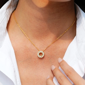 14K gold plated 925 silver necklace featuring a hollow round pendant with white crystals