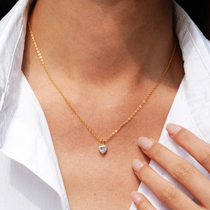 Elegant 14K gold plated 925 silver heart shaped moissanite necklace on a female model
