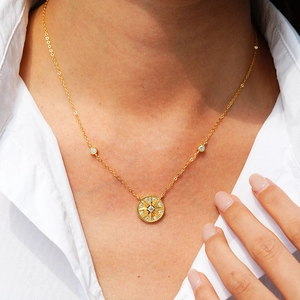 Elegant 14K gold plated 925 silver star pendant necklace shown on a model with white shirt