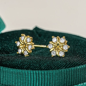 Macro detail of s925 silver sunflower stud earrings with moissanite in velvet box