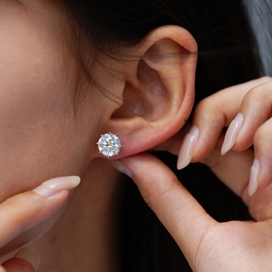 Classic 11mm round-cut moissanite six-prong stud earring shown on a model ear