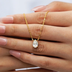 Detail of pear-shaped 1ct stone pendant on a delicate gold chain necklace for women