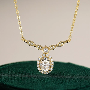 Elegant gold S925 silver necklace with oval moissanite pendant on green velvet box
