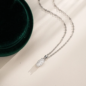 Detailed close-up of a marquise cut moissanite pendant on a silver 925 chain